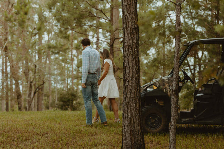Couple walking through trees